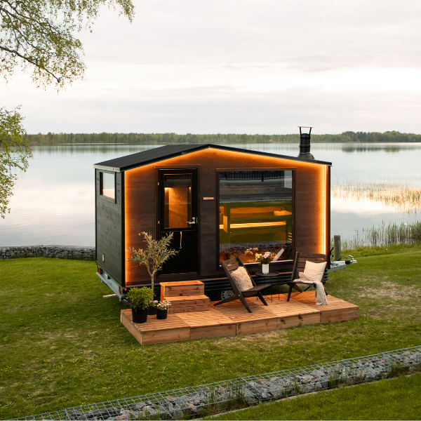 Modern cabin with wooden deck by a lake