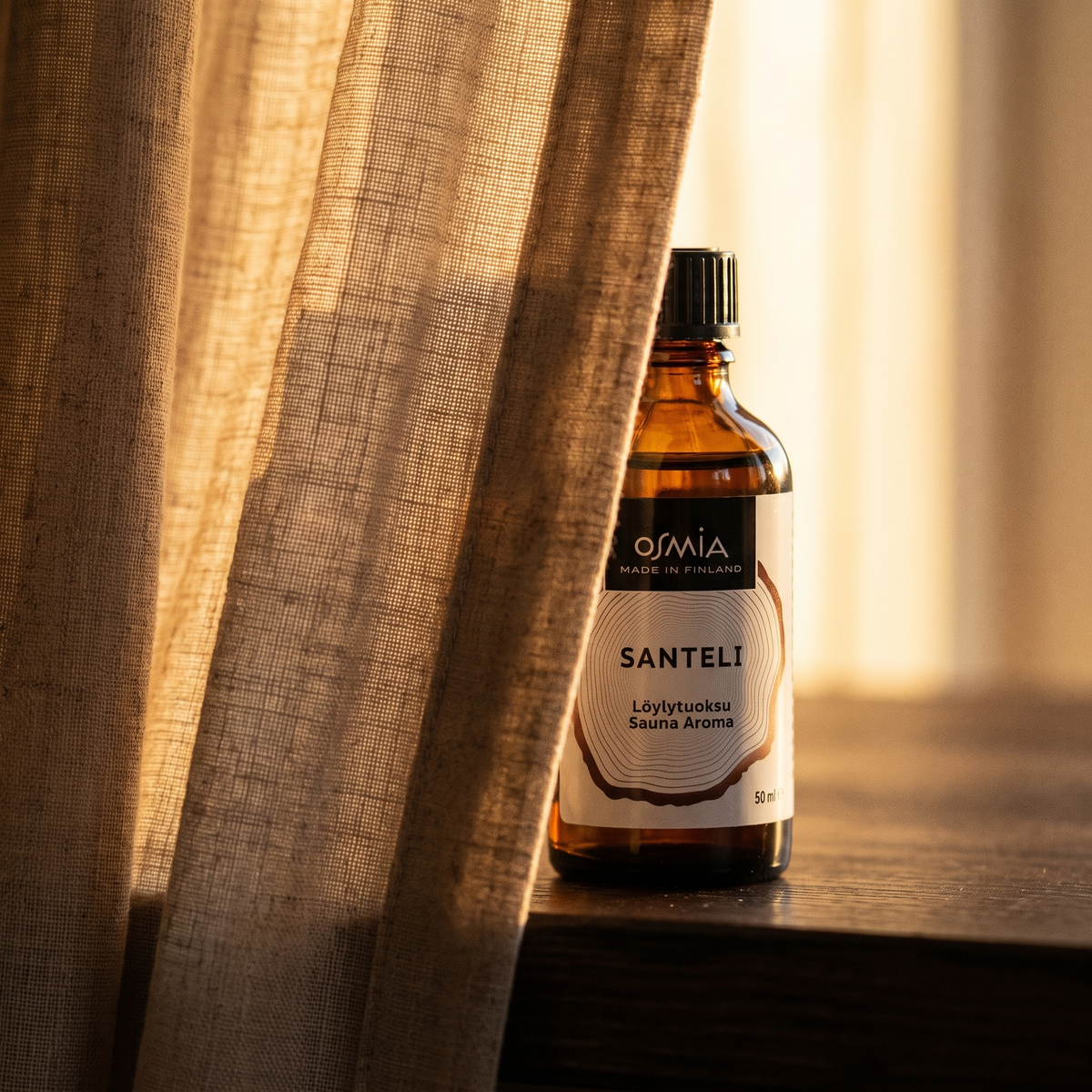 Sandalwood Sauna Aroma by Osmia (50ml) - lifestyle behind linen curtain
