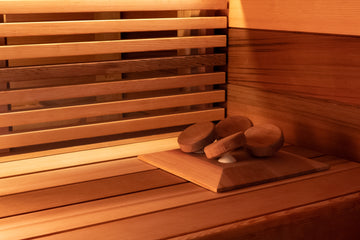 Western Red Cedar Sauna Installation with wide cedar cladding and sauna bench with slatted skirting. Pivoting Halu sauna headrest in western red cedar is also visible.