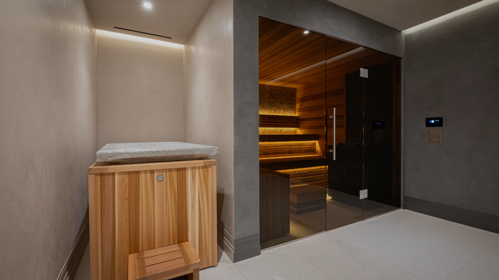 Wooden sauna with glass door in a modern interior setting