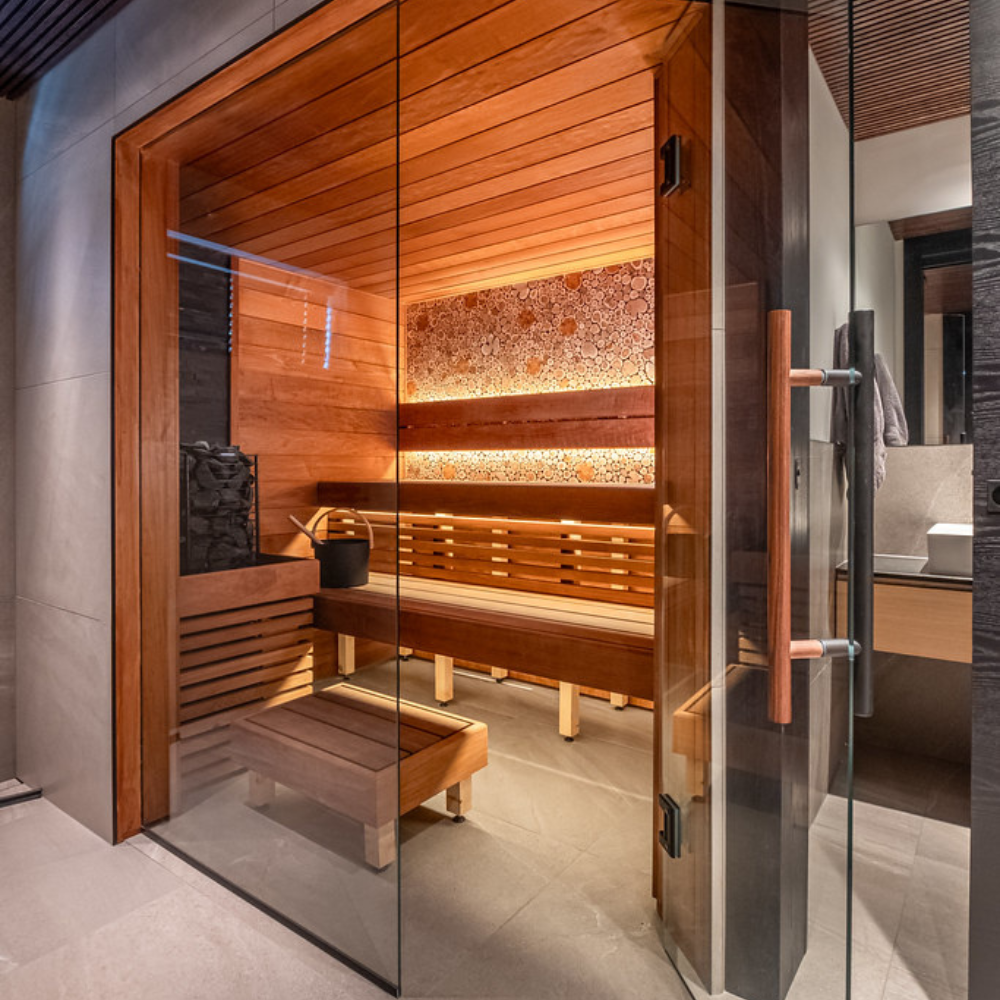 Wooden sauna with glass door in a modern setting