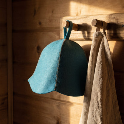 Traditional Lightweight Light Blue Felt Sauna Hat - hanging on a sauna peg