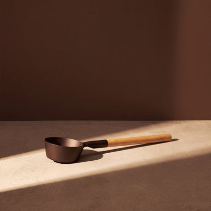 Rento Anodised Aluminium Sauna Ladle in Brown/Black - lifestyle in sunlight