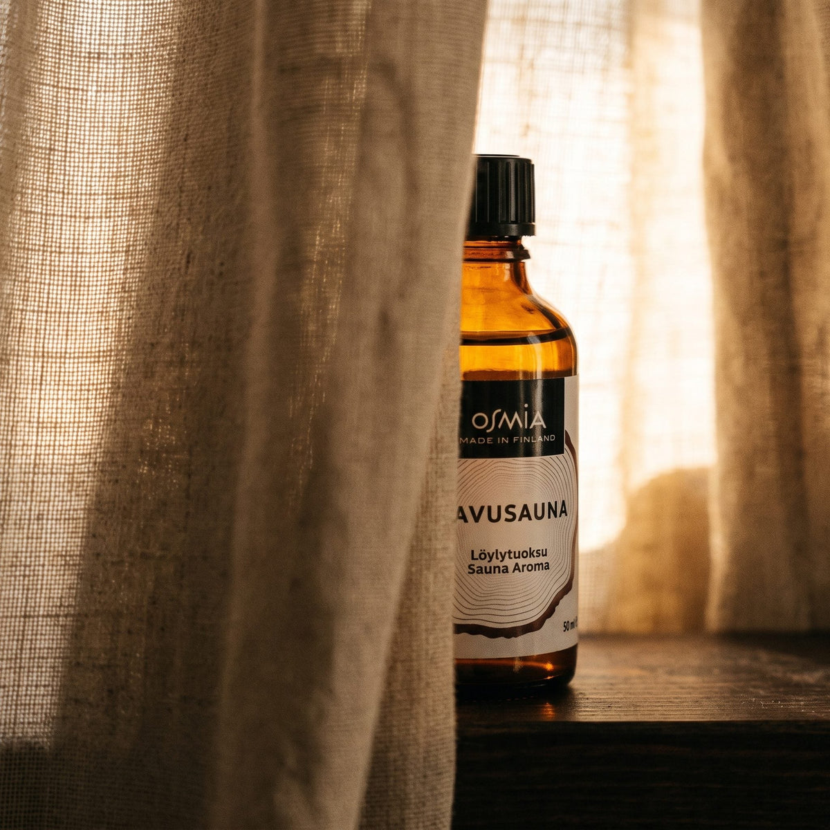 Smoke Sauna Aroma by Osmia (50ml) - lifestyle behind linen curtain