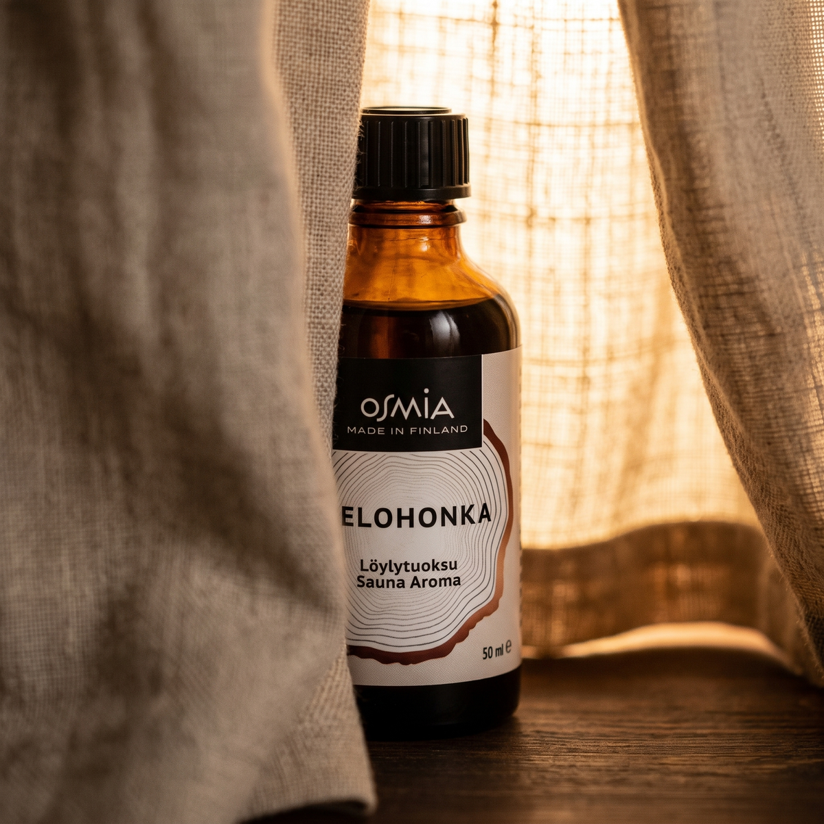 Lapland Dry Wood Sauna Aroma (Kelohonka) by Osmia (50ml) - lifestyle behind linen curtain