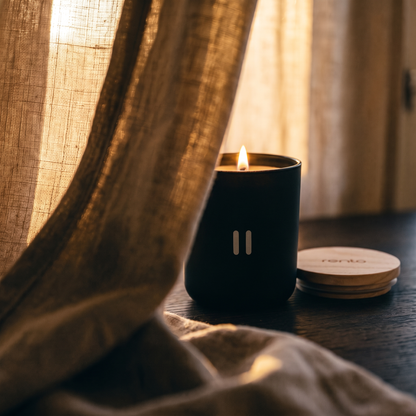 Rento Arctic Pine Scented Candle - lit behind linen curtain