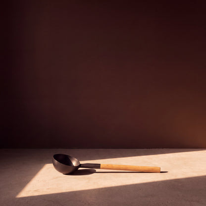 Rento Anodised Aluminium Sauna Ladle in Black - lifestyle in sunlight